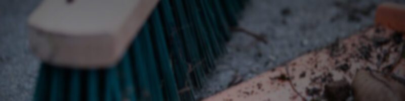 sweeping dirt and dust into a dustpan