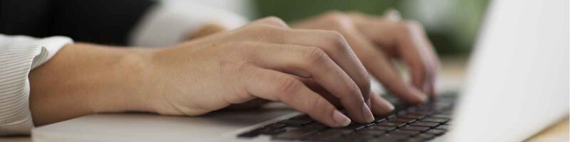 office administrator typing on a laptop computer