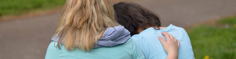 grief support with two ladies sitting on bench